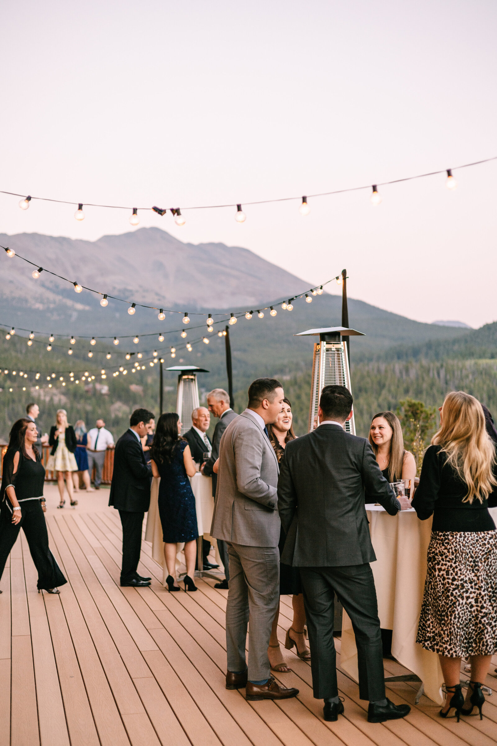 Candid of wedding cocktail hour with mountain views