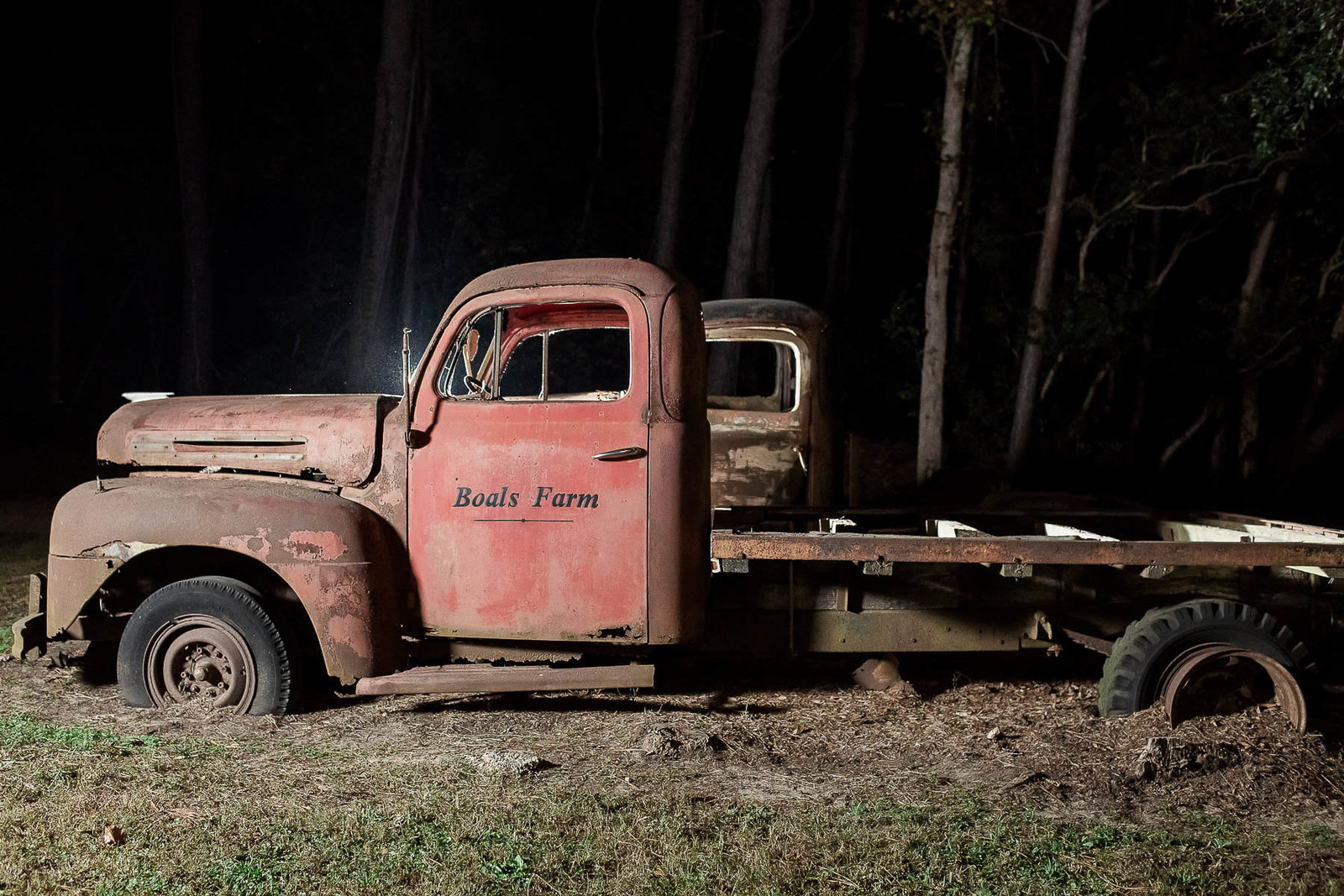 Rustic red truck sits in woods, Boals Farm, Charleston, South Carolina