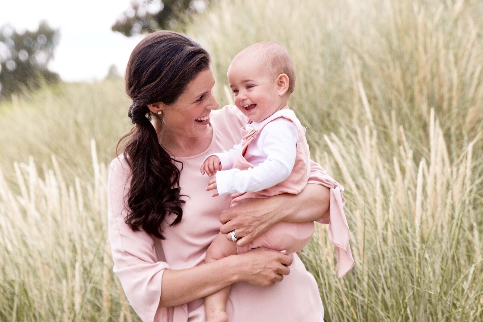 Boho natural mother and baby in a field photography kid's clothing boutique coordinating pink outfits