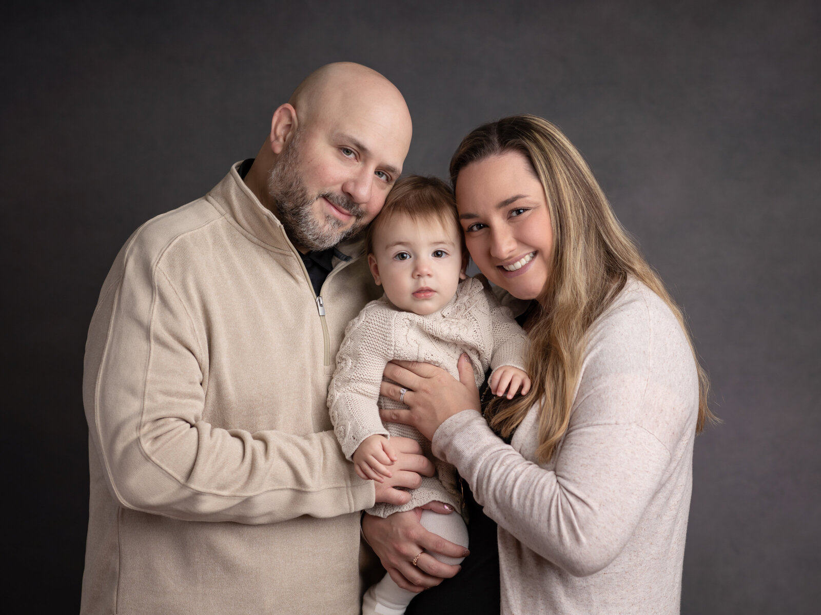 parents and daughter hugging for studio family portraits cleveland family photography