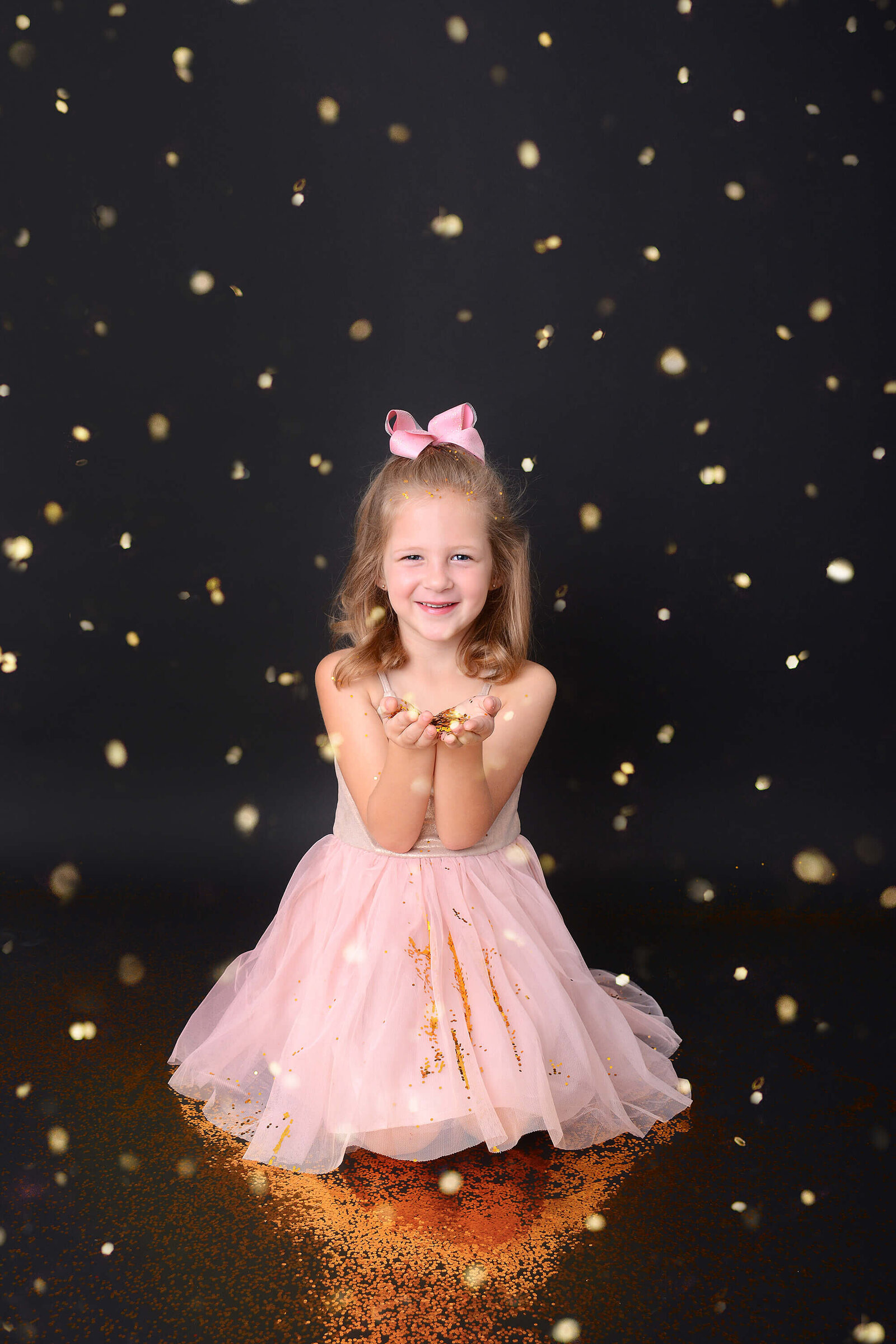 girl smiles while holding glitter at her birthday photoshoot