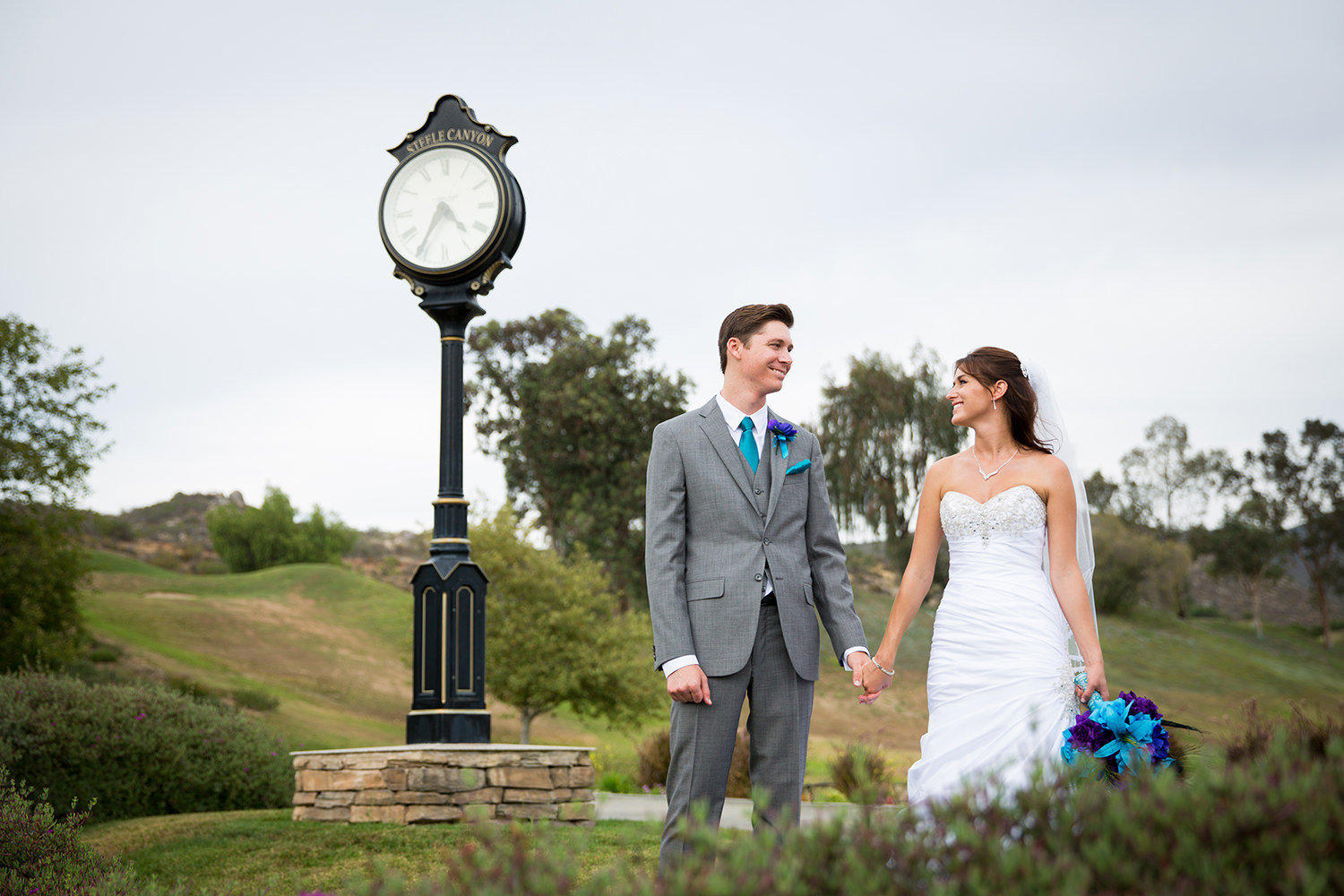 bride and groom by clock tower