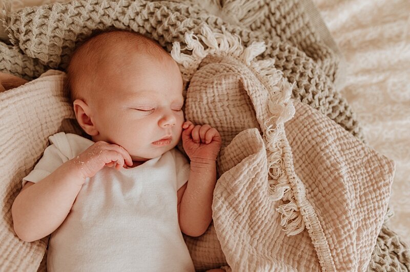 Photo of newborn baby girl all snuggled up by Vancouver newborn photographer