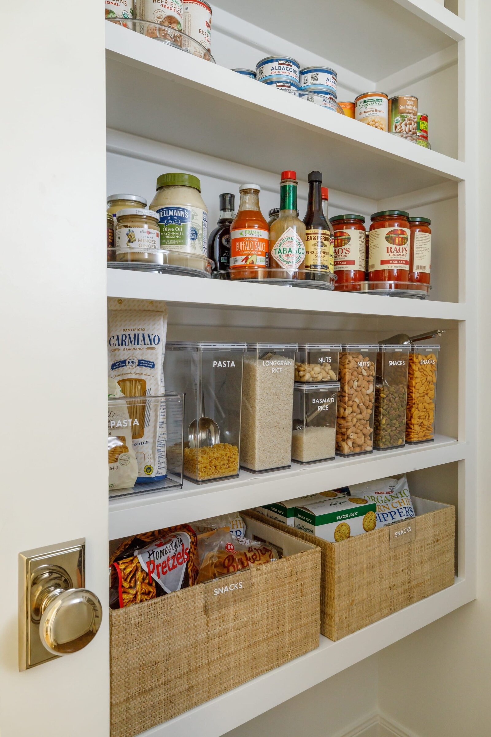 vision and hammer organizing pantry shelves with sauces 