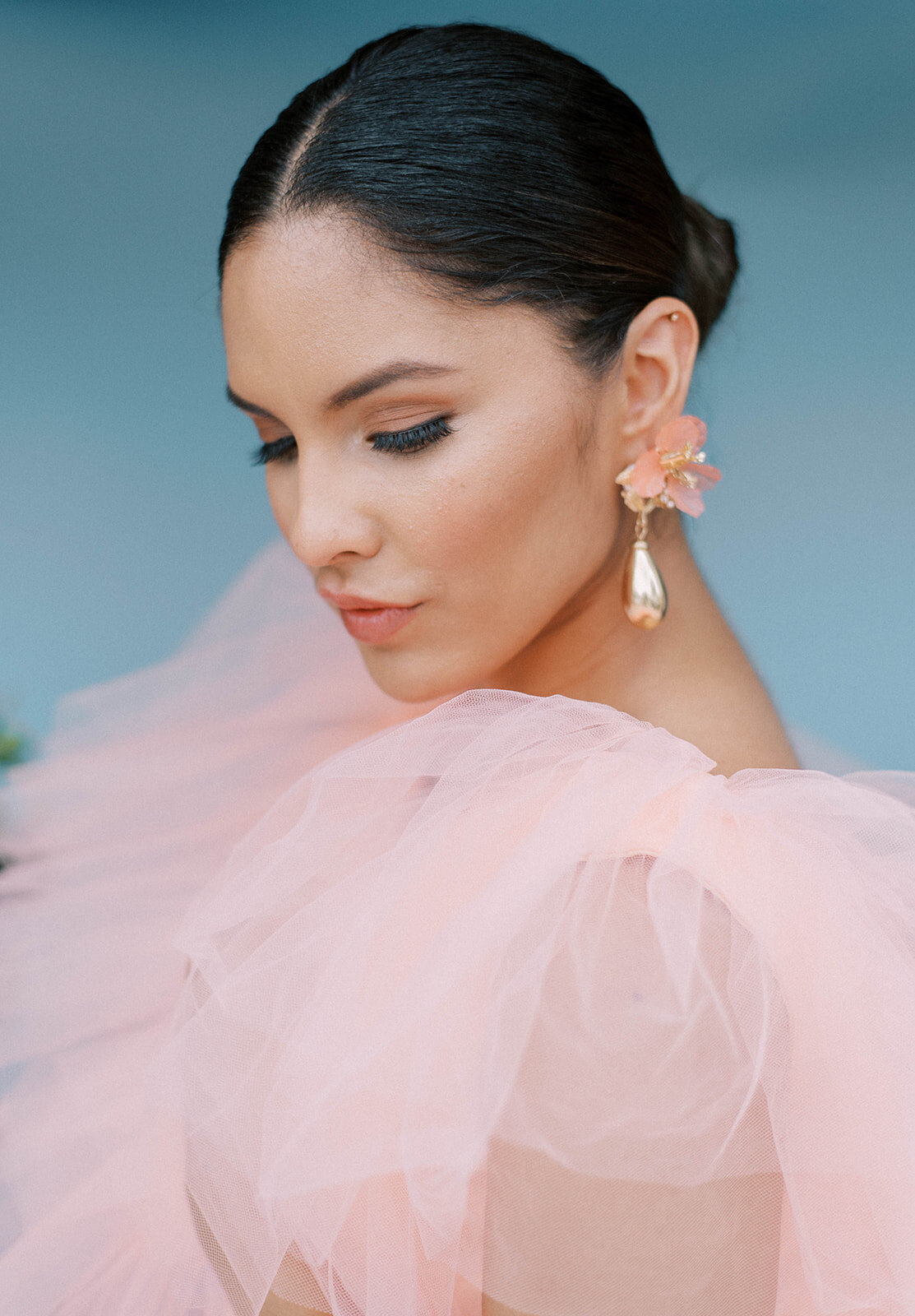 woman wearing pink dress wearing gold earrings