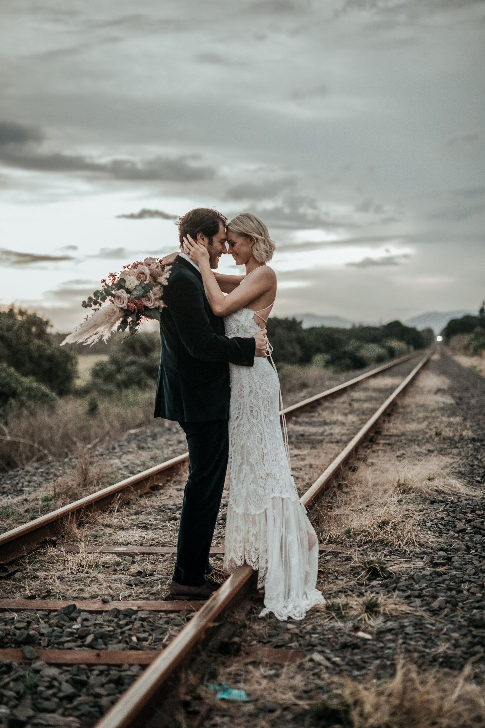 Newlyweds on railway with soft focus background