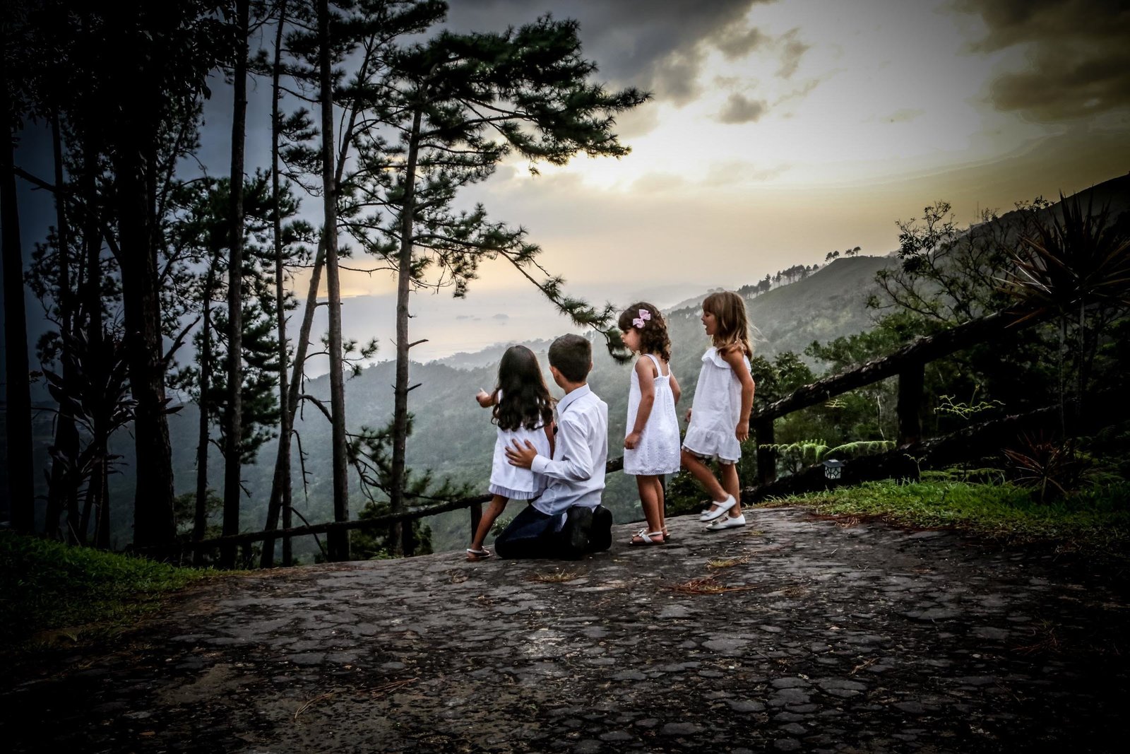 Four young children look at an expansive view. Photo by Ross Photography, Trinidad, W.I..