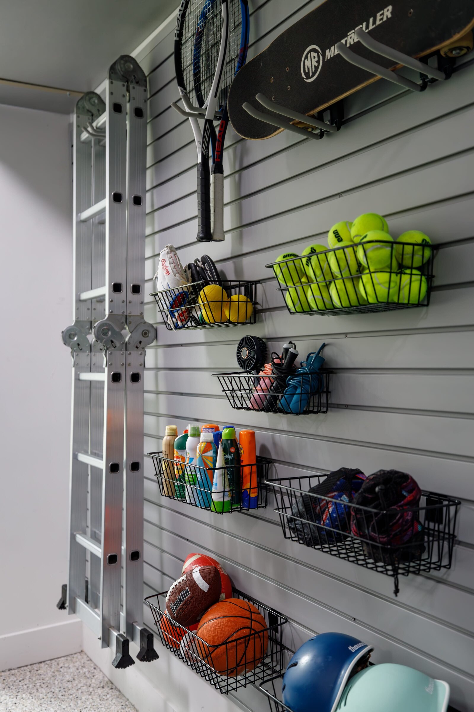 vision and hammer organizing garage wall with ladder and baskets