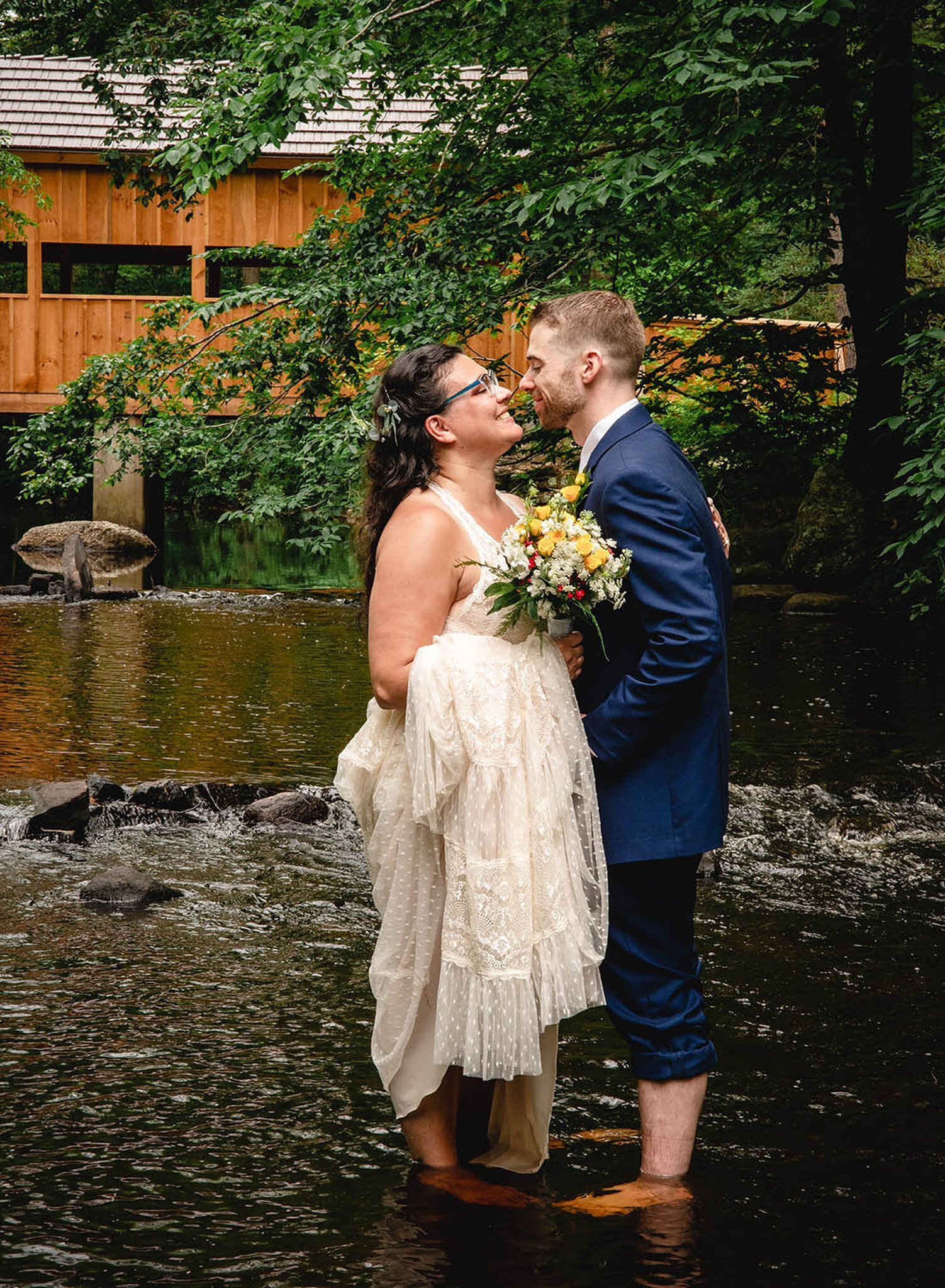 New England elopement couple standing in river