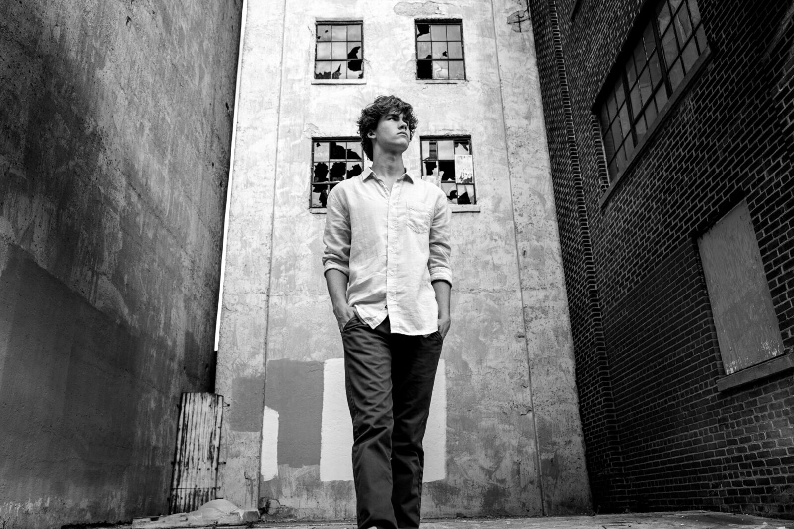 Wayzata Minnesota high school grad photo of boy in white shirt in urban city scene