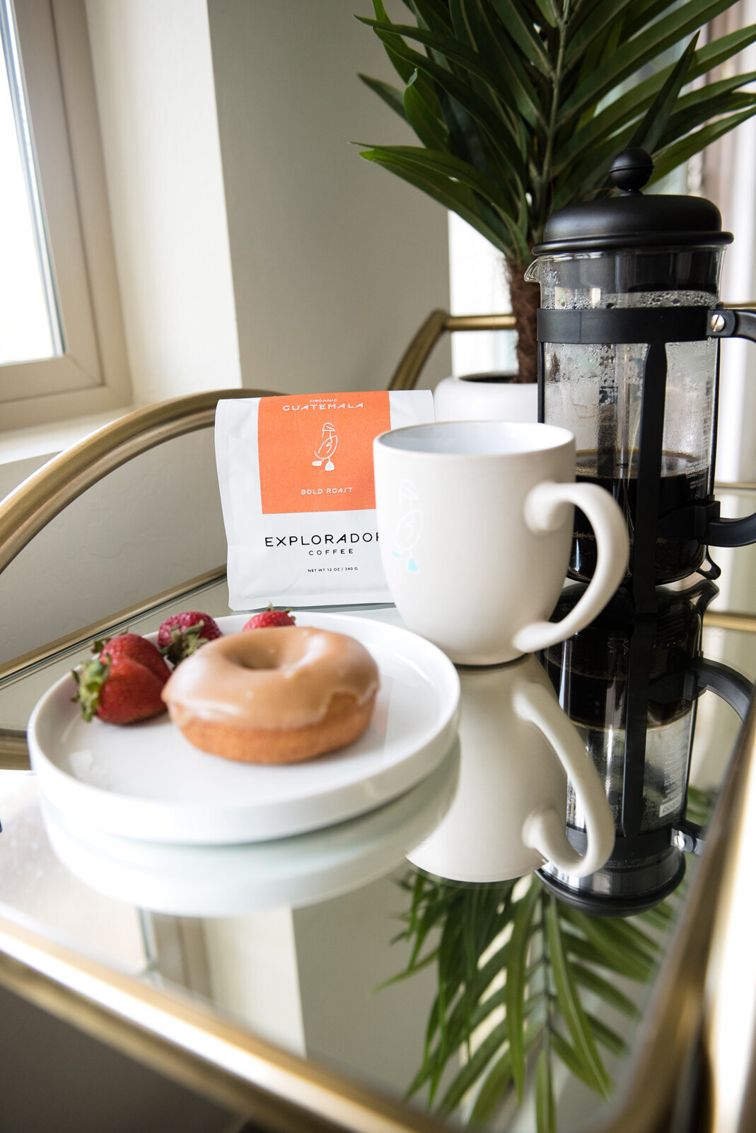 Glass Bar cart with coffee and a doughnut