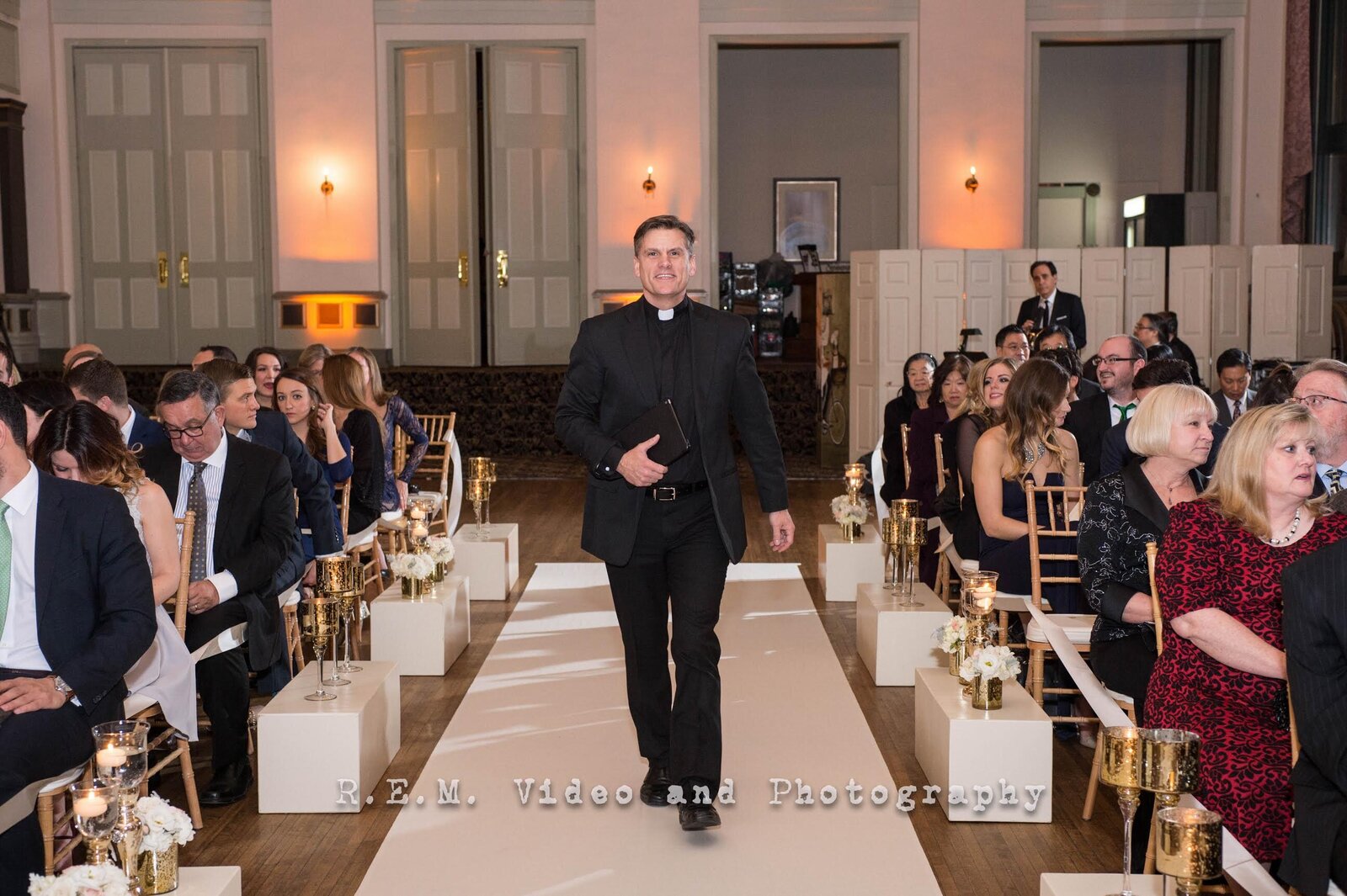 Wedding officiant walks down aisle to officiate a wedding