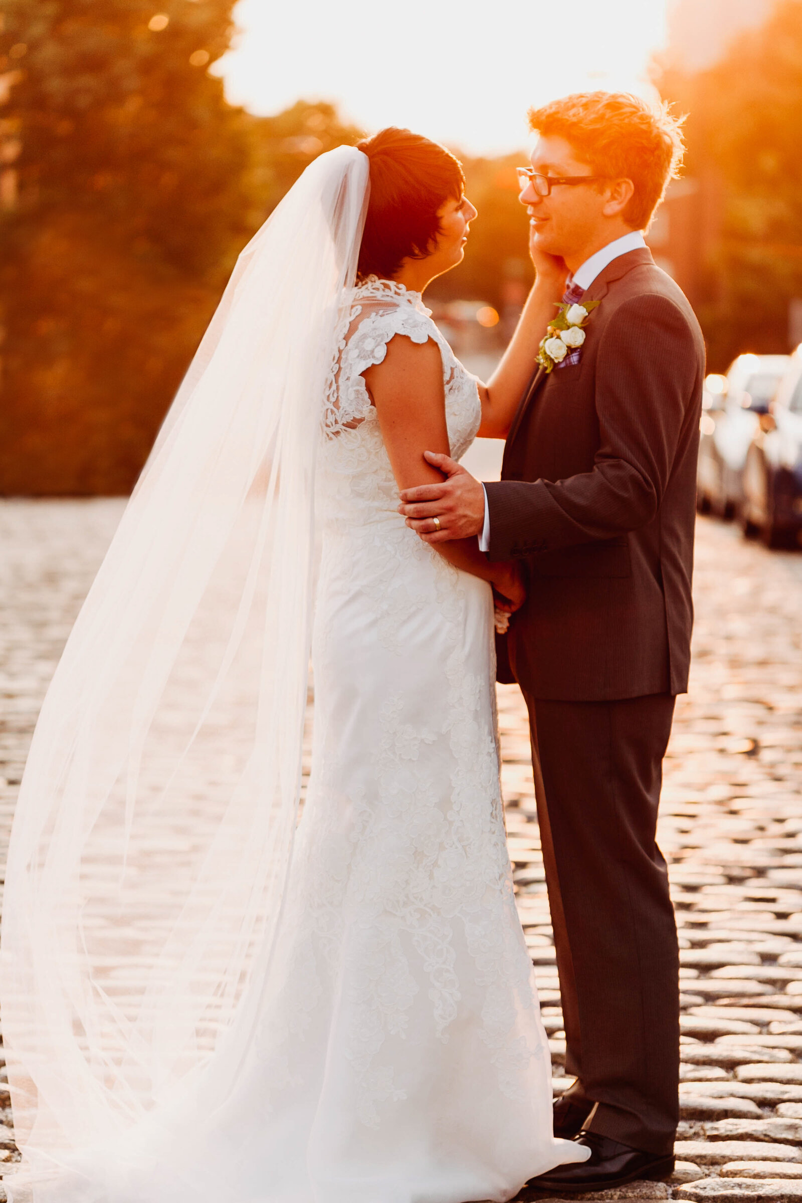 bride and groom at sunset in cobblestone street