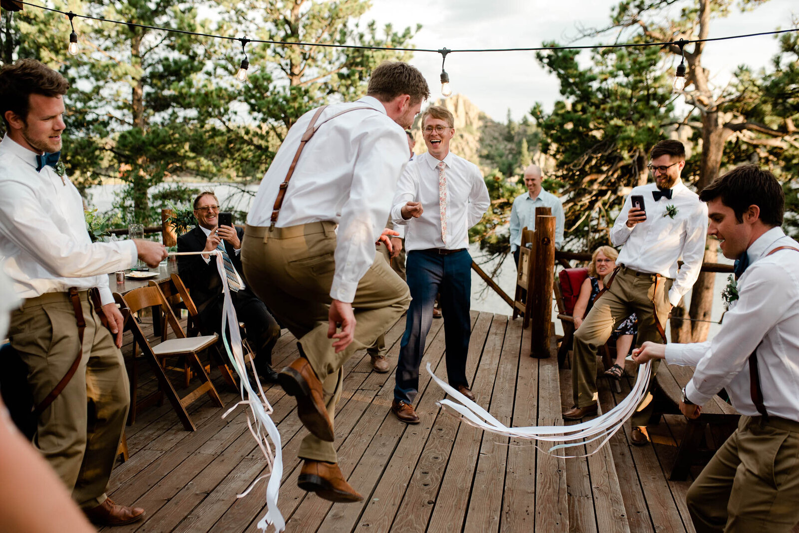 groomsmen dancing with streamers at red feather lakes wedding