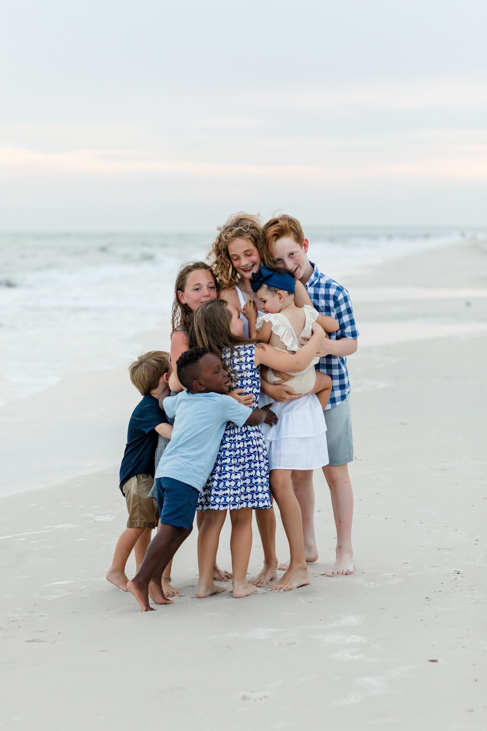 Cousins in group hug during photo session on Pensacola Beach
