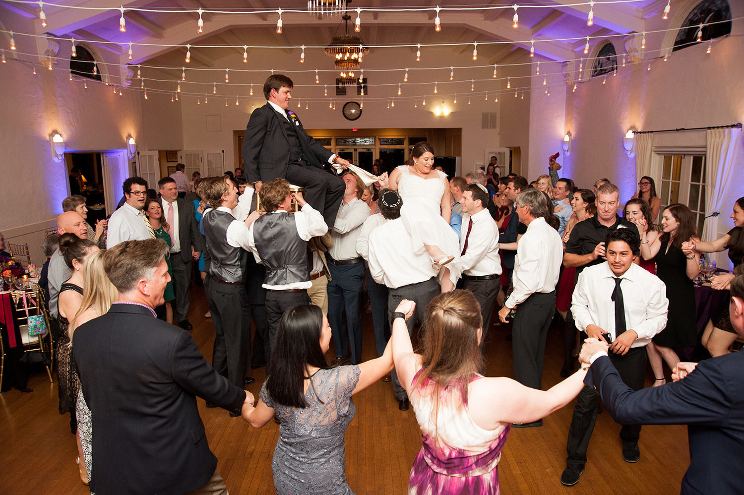 bride and groom on chairs dancing