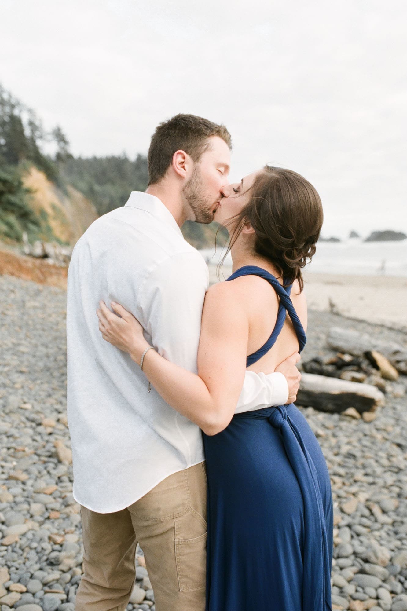 Engaged couple kisses on Oregon coast beach