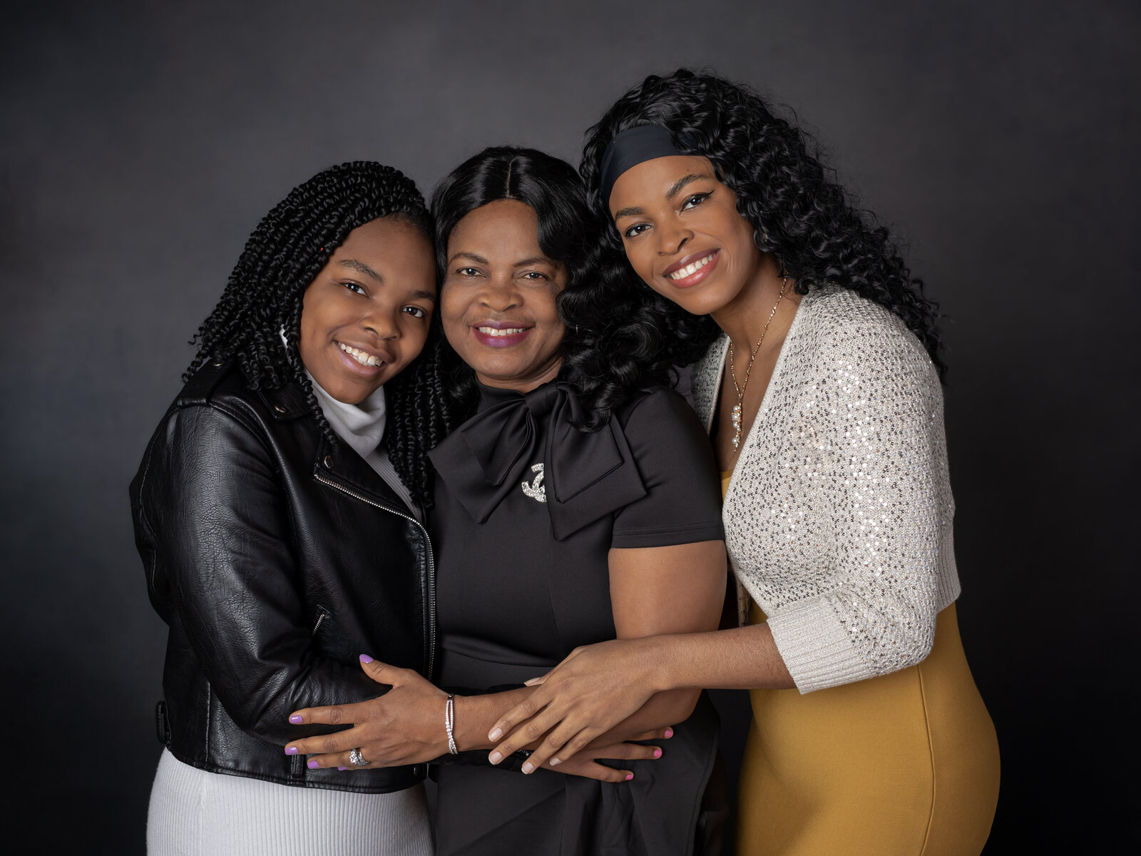 mother and two daughters hugging for studio family portraits