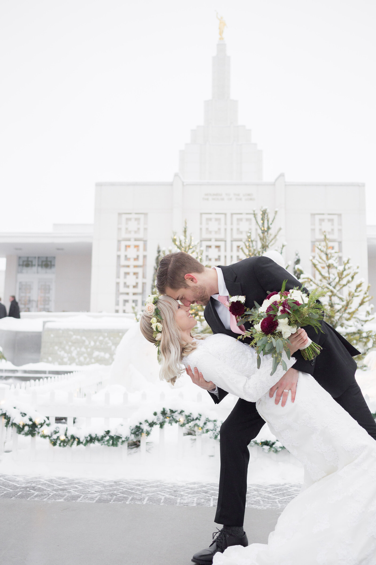 Seattle Wedding Photographers capture bride and groom dip kiss in front of temple
