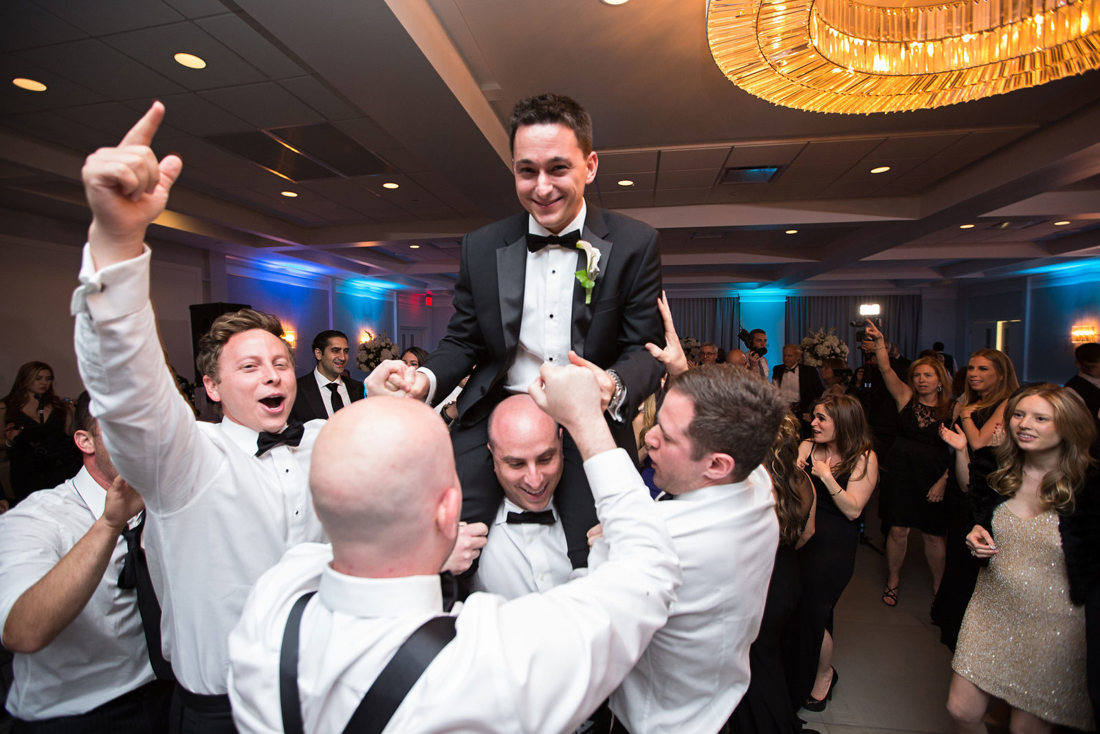 groom getting lifted by his groomsmen at Engineers Country Club