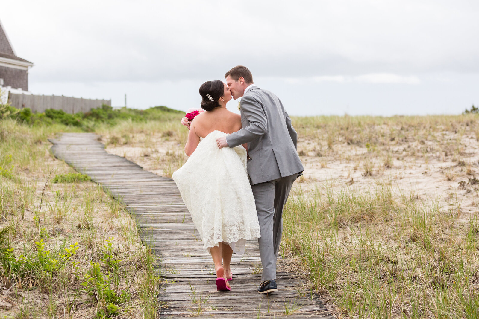 bride adn groom walk to beach at wychmere