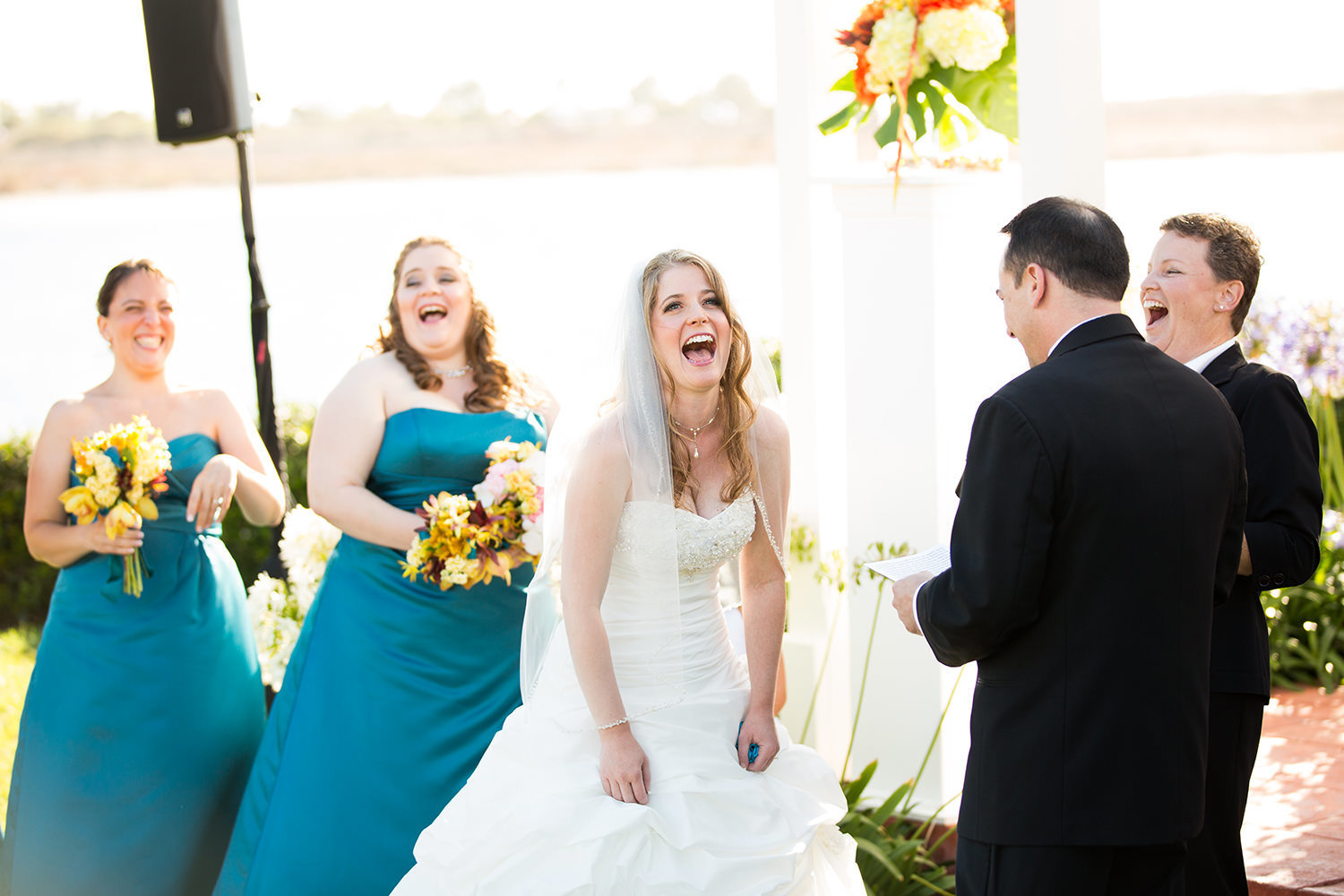 bride laughing at grooms speech at ceremony