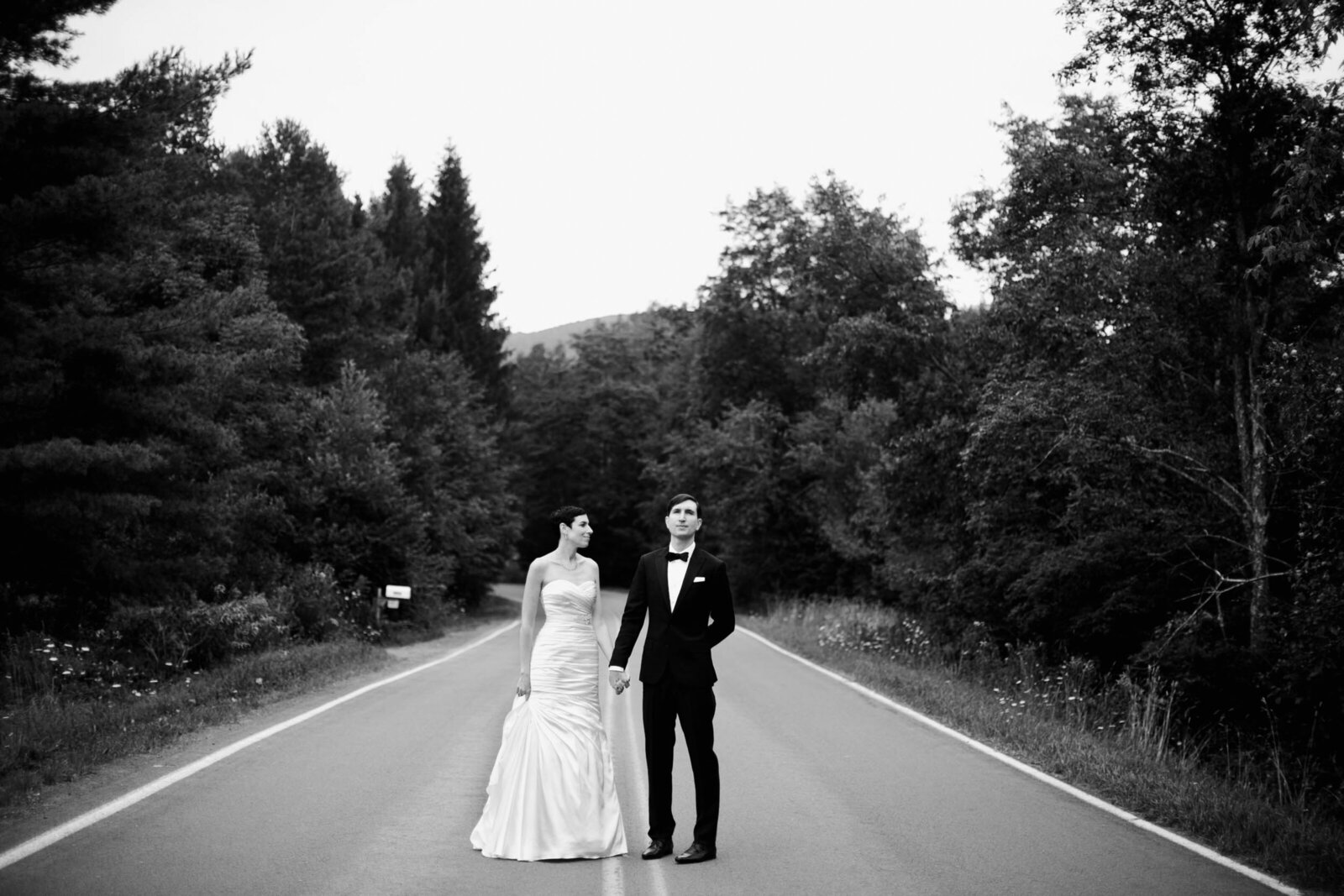 bride and groom on mountain road