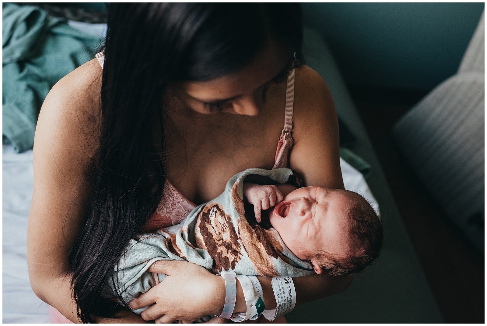 mom holding new baby boy in hospital newborn fresh 48 photo session Emily Ann Photography Seattle Photographer