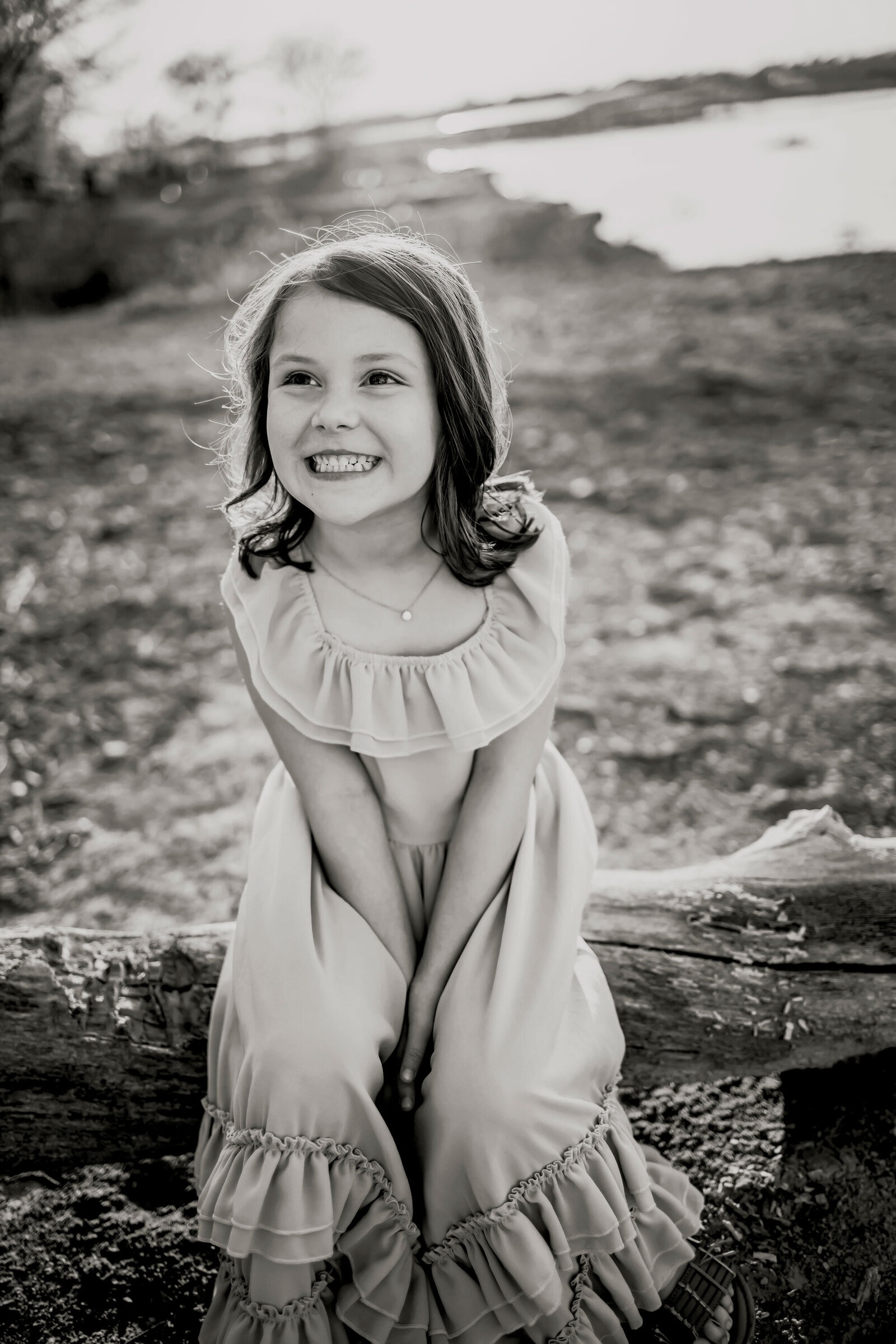 child smiling at Lake grapevine at a family session
