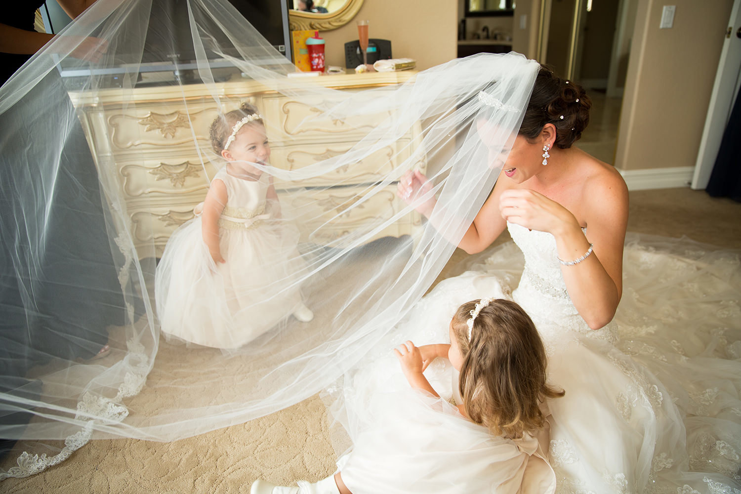 Wonderful moment between the bridesmaid and her flower-girls