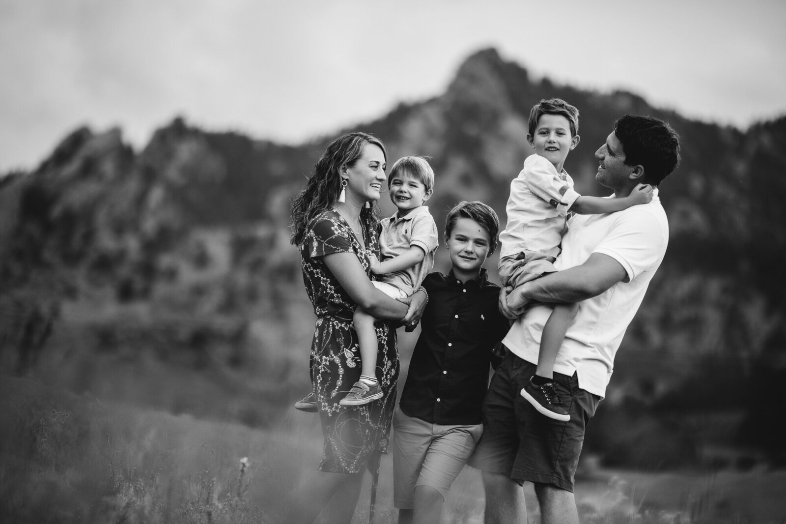 Family Photographer, black and white image of family posing with mountain in the background
