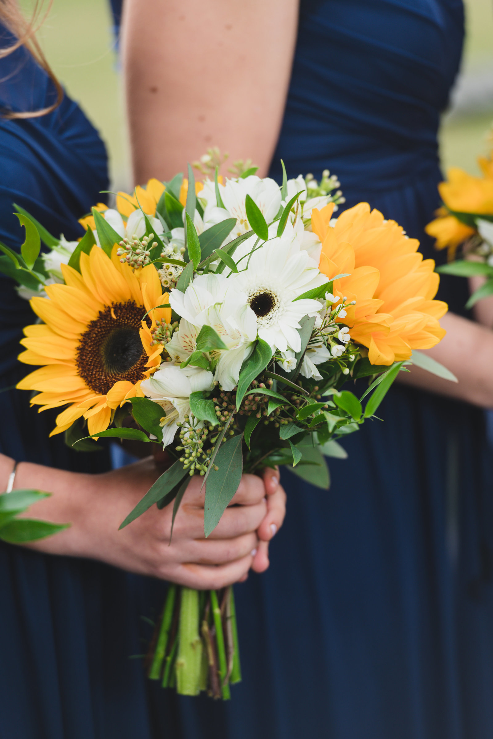 photo of bridesmaids bouquet in hands from wedding at Three Village Inn