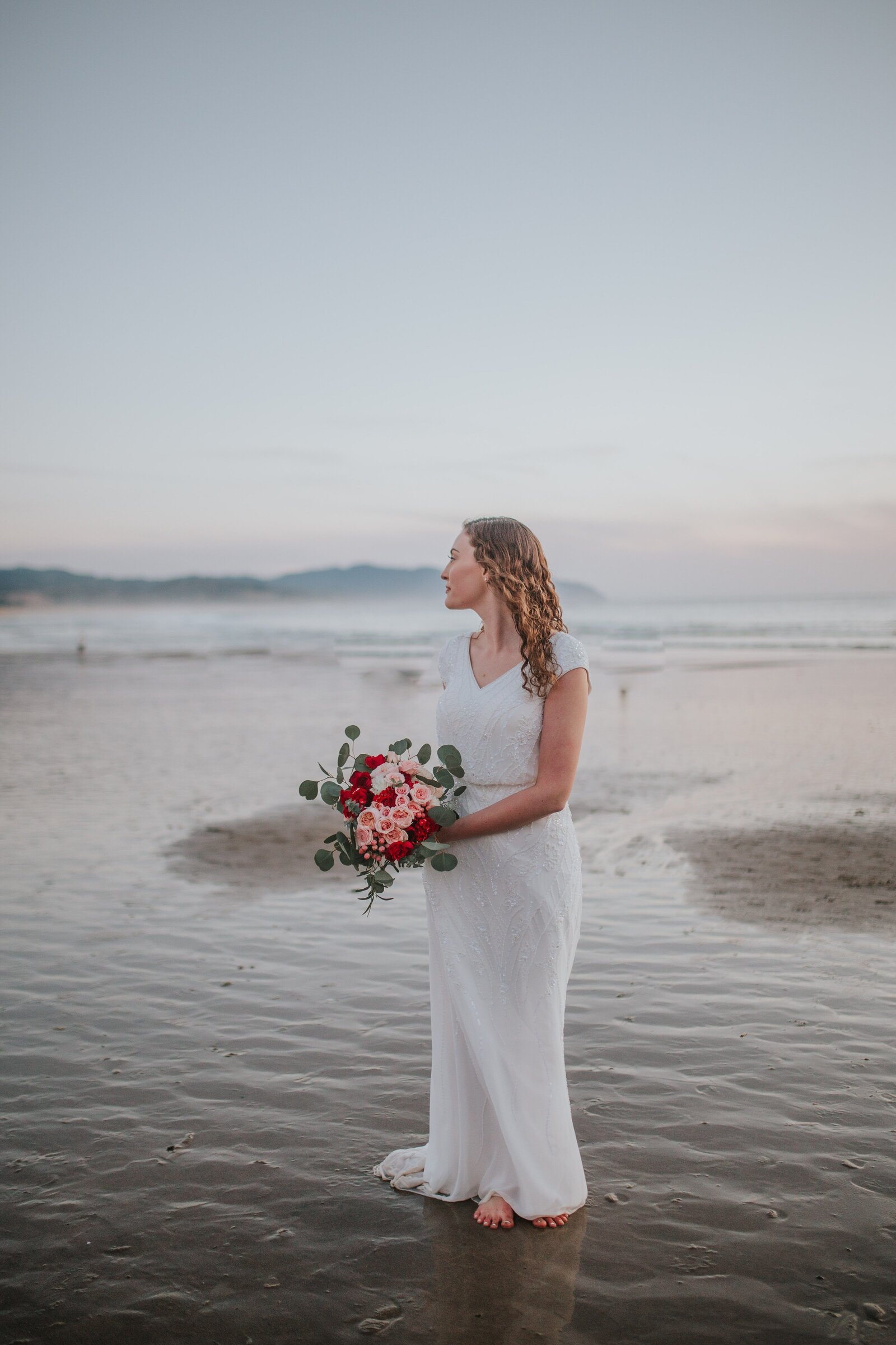 Sacramento Wedding Photographer captures beach wedding with bride standing barefoot on beach