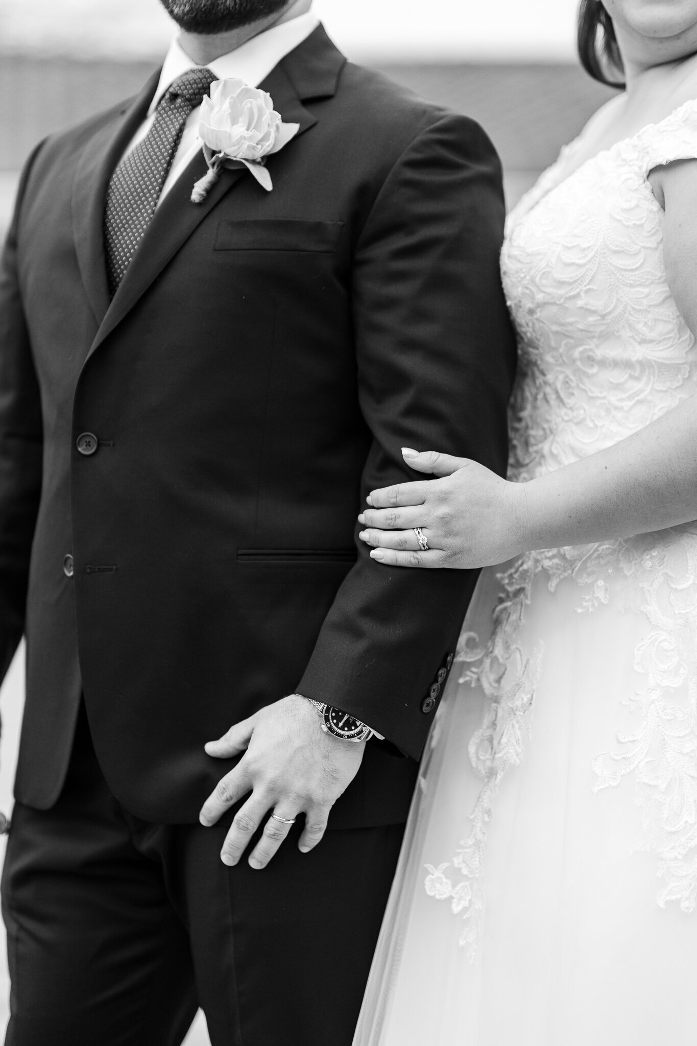 bride holding grooms arm close up