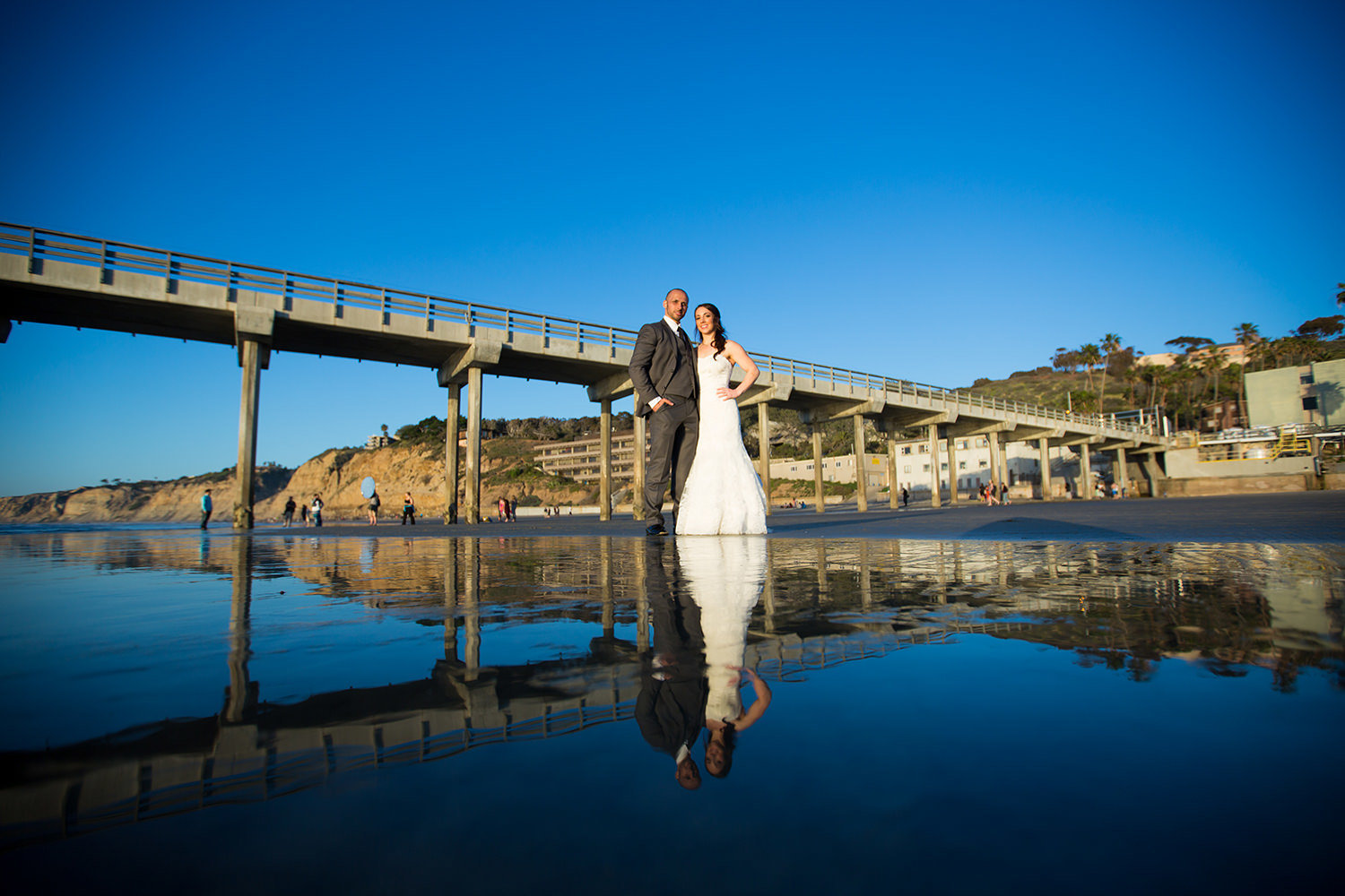 bride and groom with scripps pier