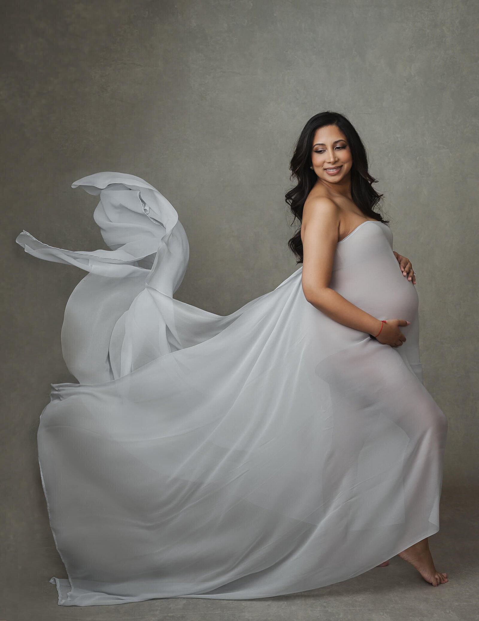 studio maternity photography using flowing fabric