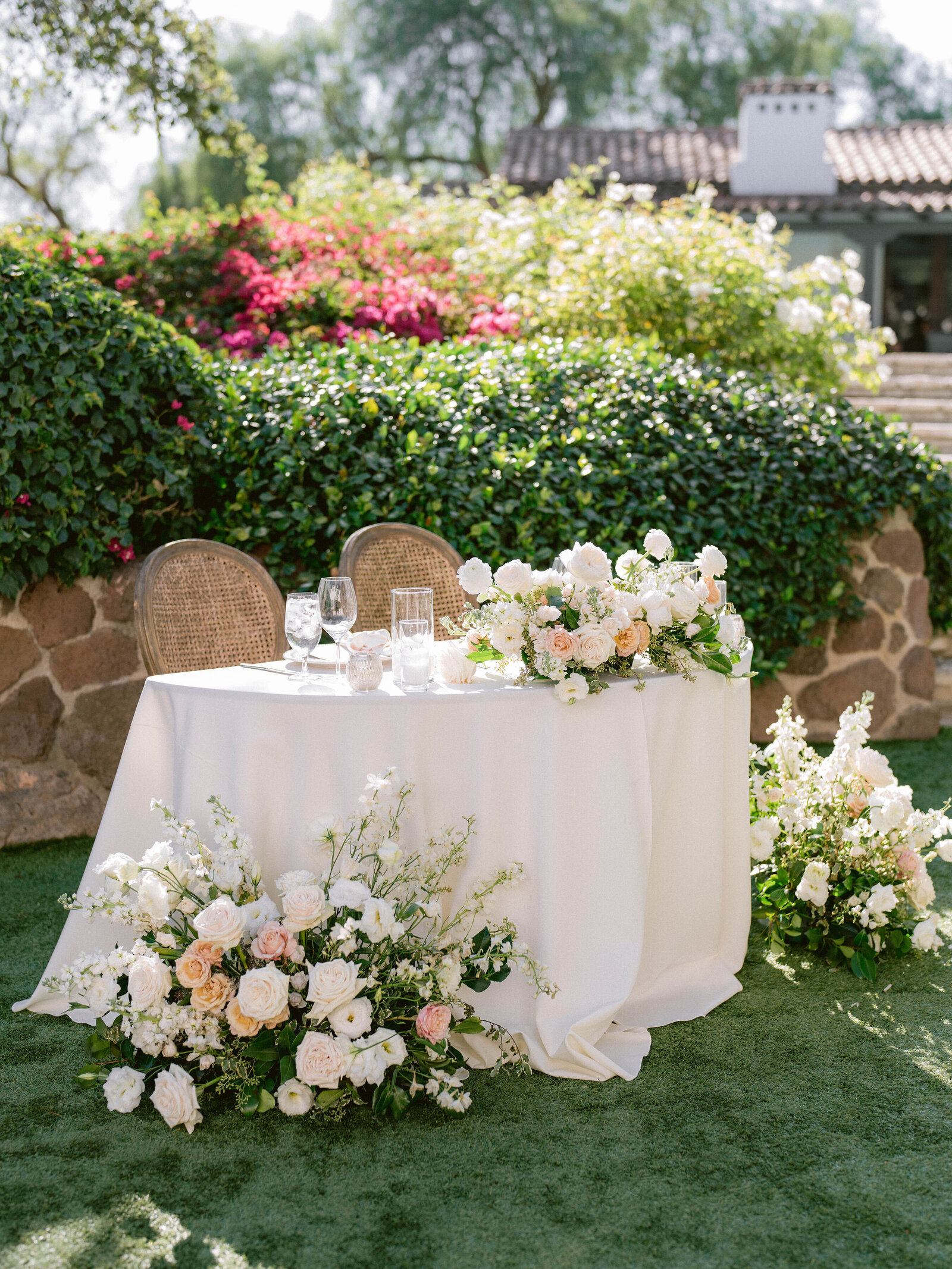 This wedding dinner table showcases large uniquely designed flower bouquets to help the newly weds stand out.