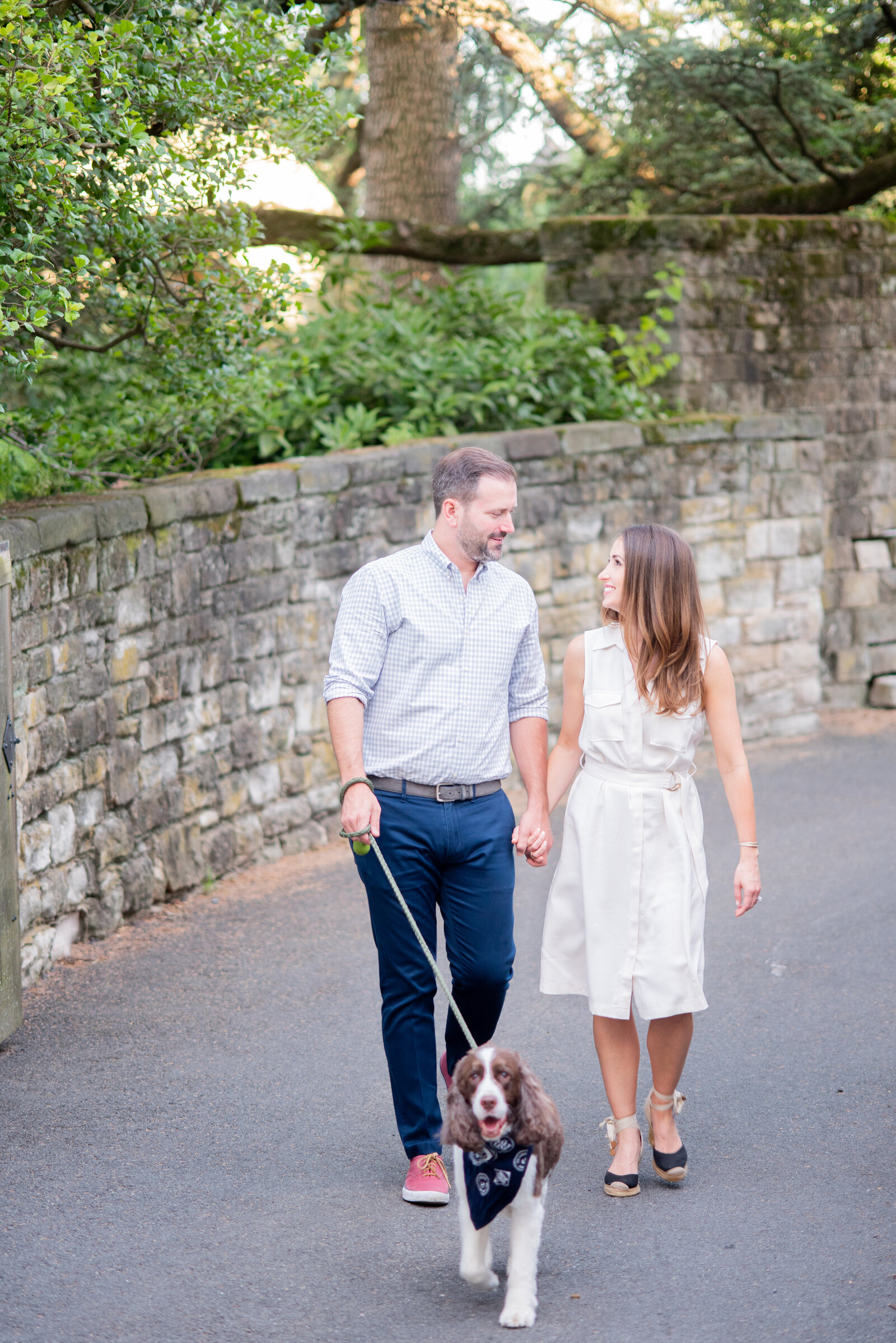 engaged couple taking engagement photos at National Cathedral engagement session