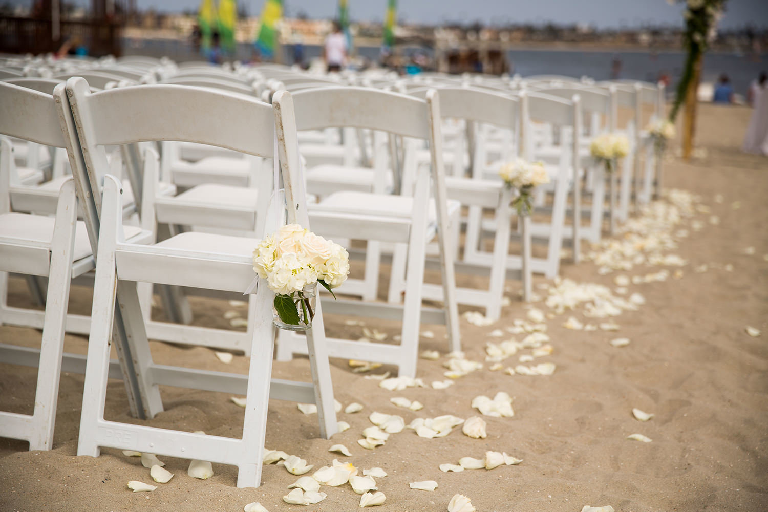 ceremony with roses petals in the sand