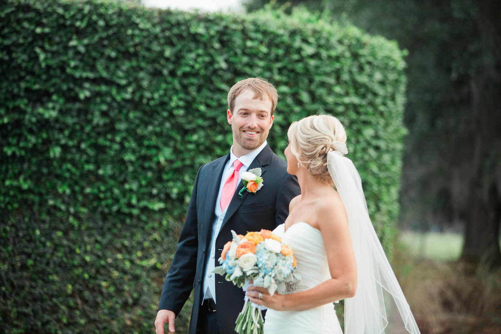 Bride and groom smile by ivy covered wall, Dunes West Golf and River Club, Mt Pleasant, South Carolina