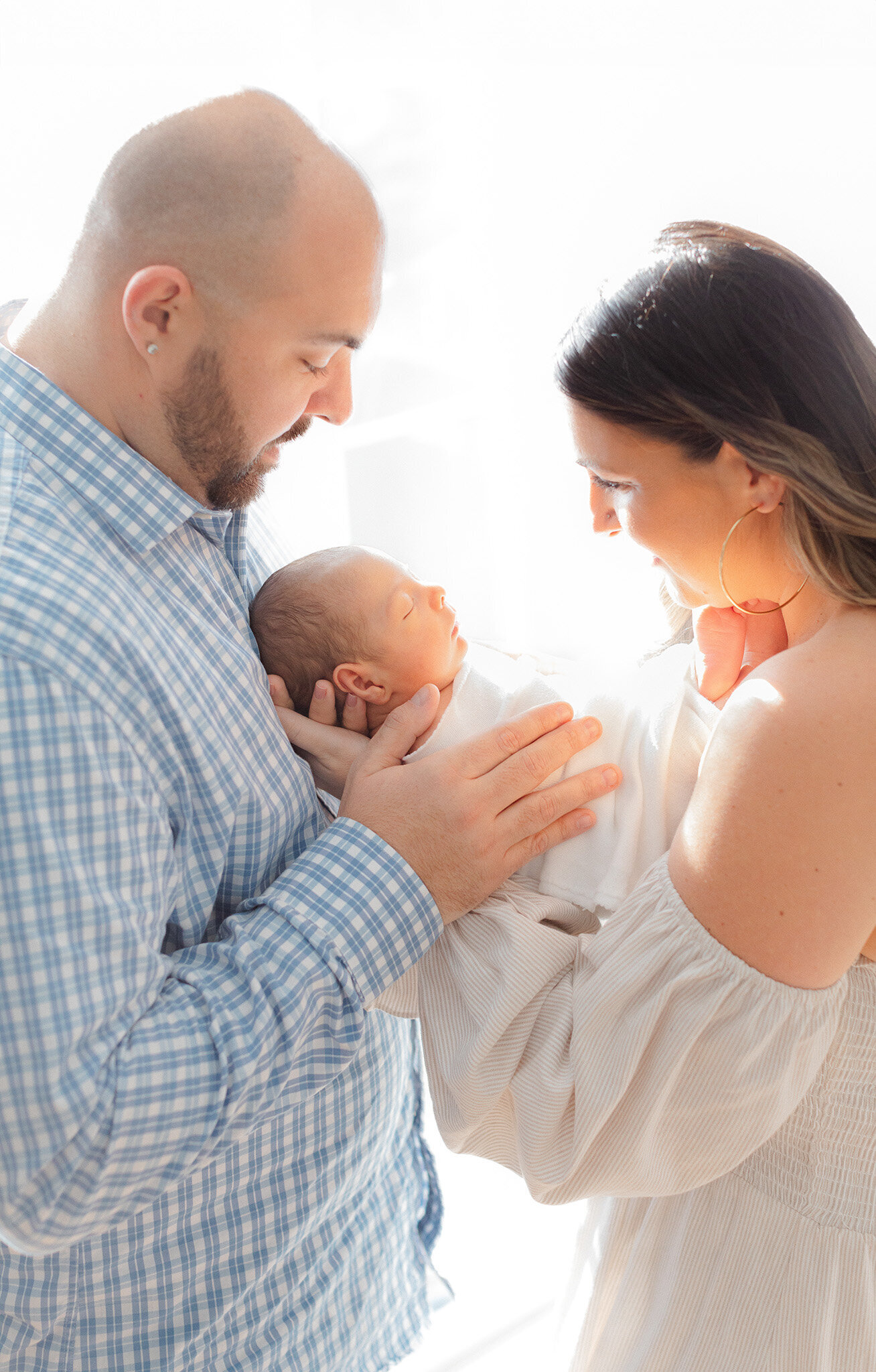 new mom and dad hold their baby during massachusetts newborn photoshoot