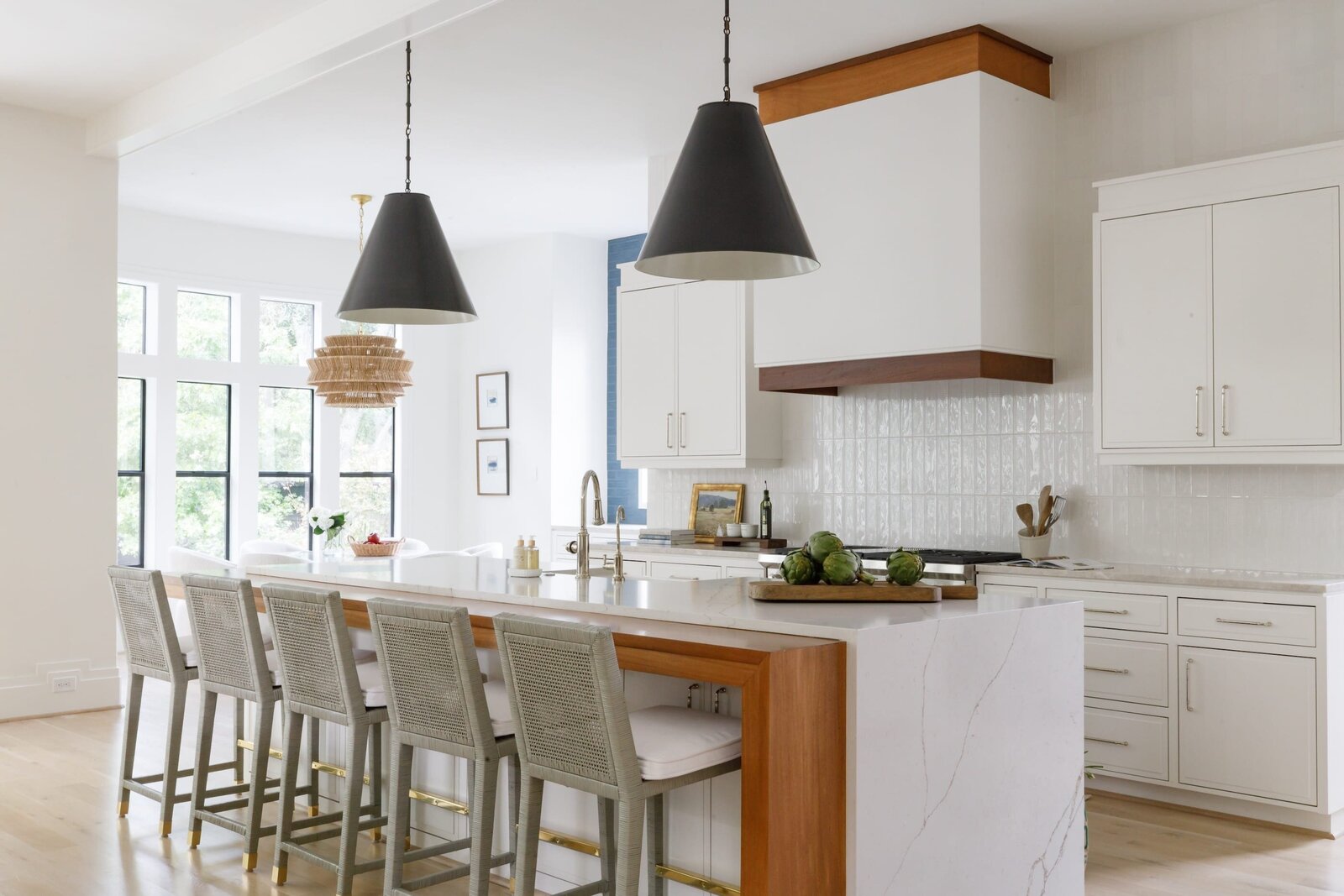 vision and hammer kitchen with barstools and black pendants over island