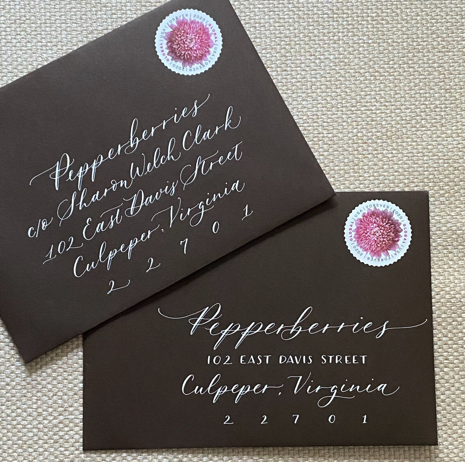 Elegant black envelope with custom calligraphy with stamps