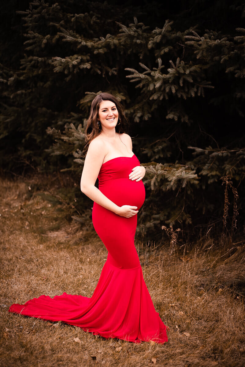gorgeous mom in red maternity gown for maternity photos in Toronto