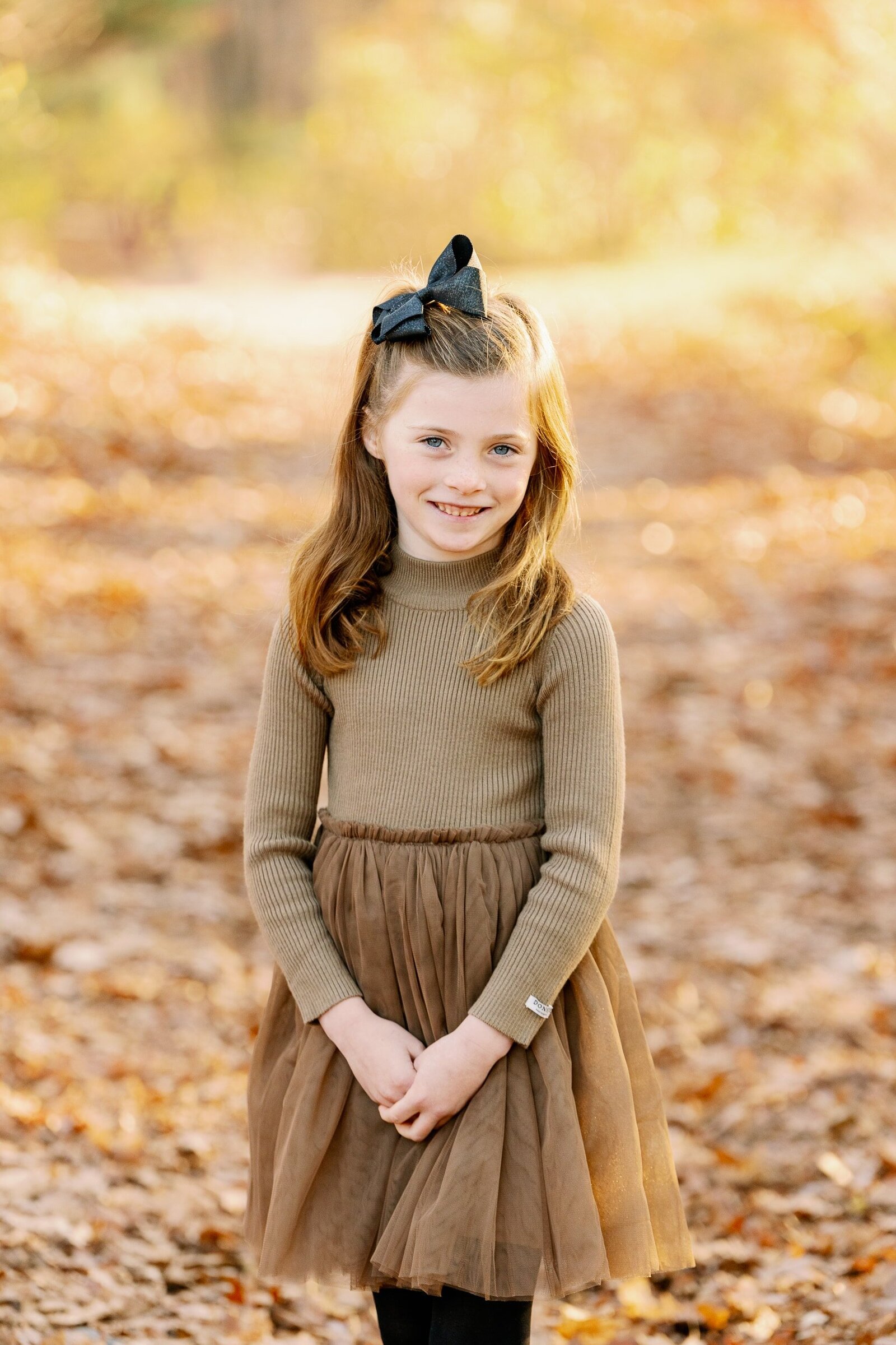 girl in brown dress smiling