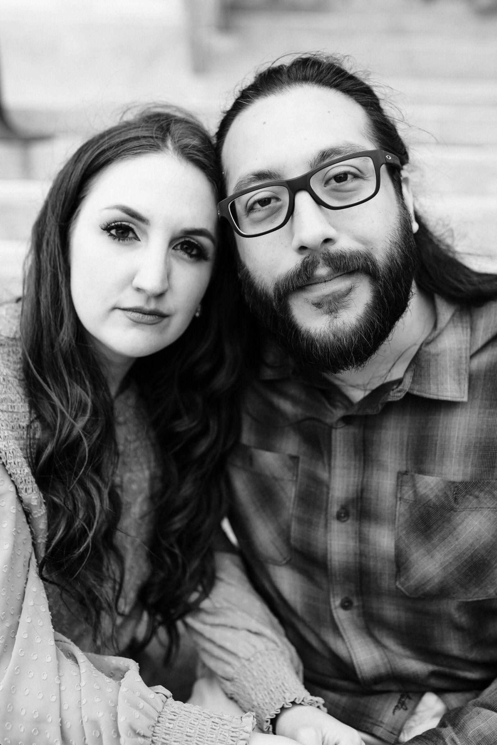 Couple looking at the camera with a serious pose in black and white