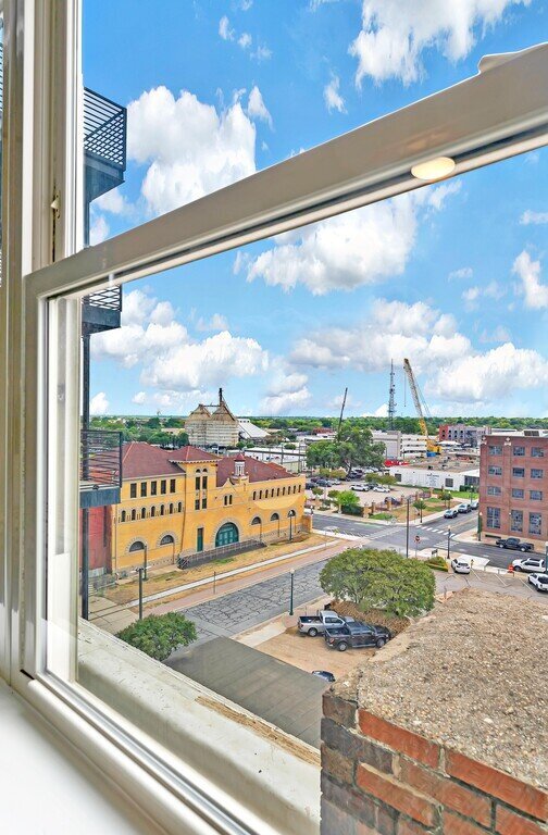 View of the city from this one-bedroom, one-bathroom vacation rental condo with sleeping space for four is walking distance from the Silos, McLane Stadium, and Baylor University in downtown Waco, TX