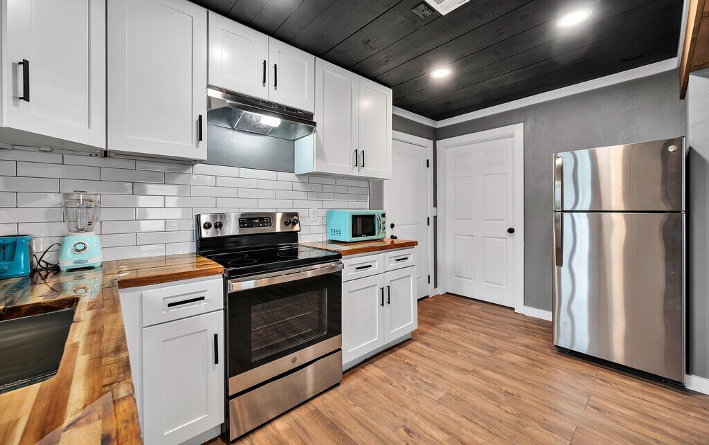 Kitchen with stainless steel appliances in this two-bedroom, one-bathroom vacation rental house for five located just 5 minutes from Magnolia, Baylor, and all things downtown Waco.