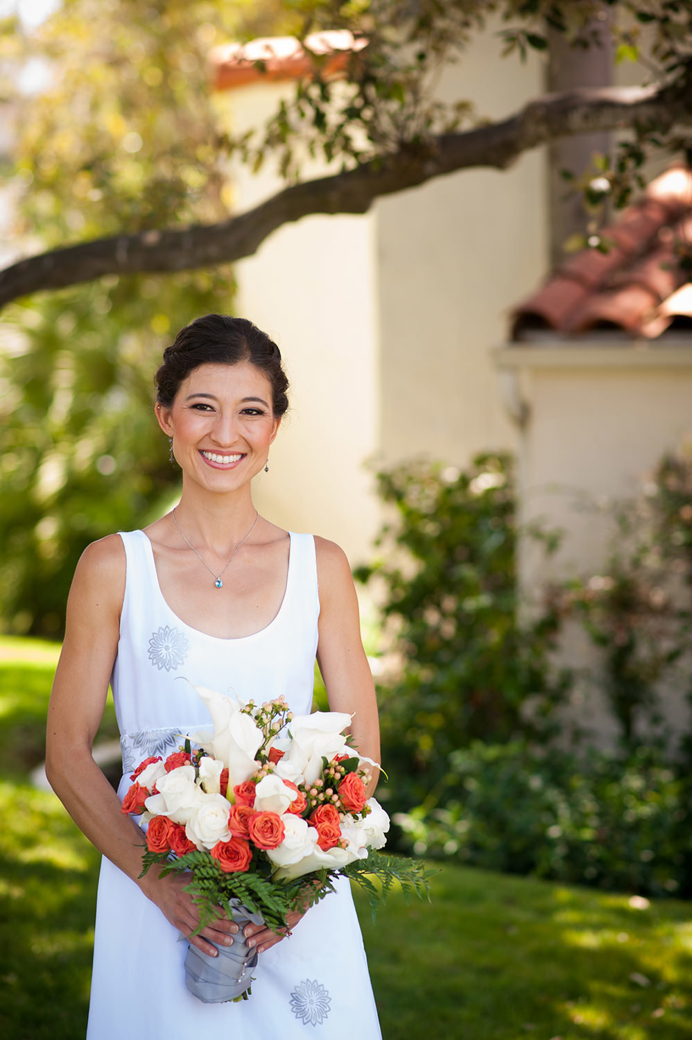 bride with white and orange bouquet