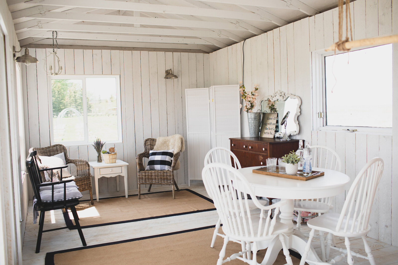white cottage with white tables and chairs - wicker chairs